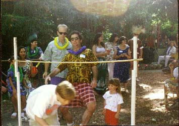 Aaron does the limbo at Tiki King's luau