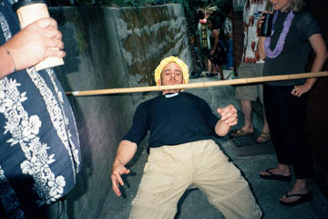 practicing the limbo at Tiki King's luau