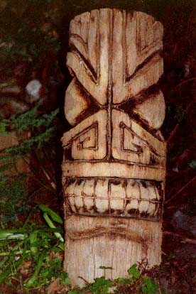 Palm log Tiki 1, a carving by Tiki King