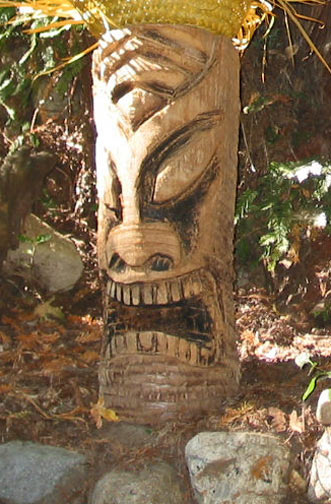 Palm log Tiki 3, a carving by Tiki King